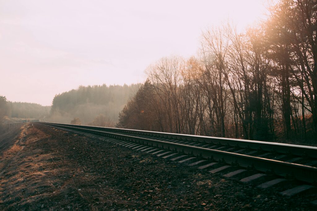 pexels-photo-673803-673803 Foggy railway track through a misty autumn forest in Belarus, capturing serene nature and transportation scene.